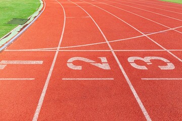 Wall Mural - The curved lane in running track or athlete track in stadium. Running track is a rubberized artificial running surface for track and field athletics