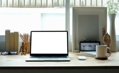 Wall Mural - Front view computer laptop with empty display on wooden table.