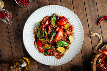 Wall Mural - Chinese warm beef salad with vegetables and sesame seeds