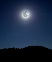full moon over mountain at night