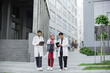 © sofiko14 - Three Arabian Muslim doctors, in medical suits and coats, discussing patient's x-ray tomography scan, walking outside on the background of modern hospital with stairs