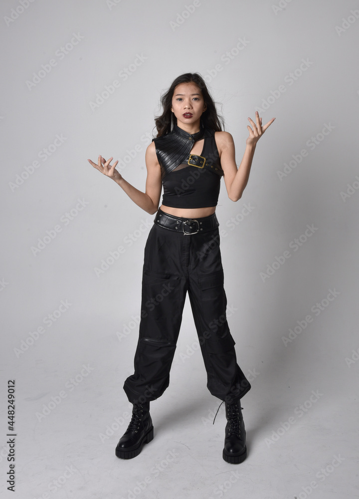 Full length portrait of pretty young asian girl wearing black tank top ...