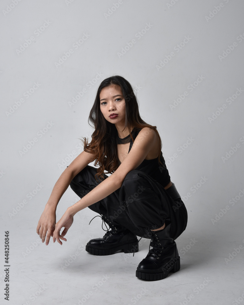 Full length portrait of pretty young asian girl wearing black tank top ...