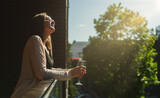 Fototapeta  - Woman in sunglasses enjoying white wine on the balcony.