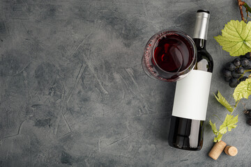 Wall Mural - Bottle of red wine with label. Glass of wine and grape. Wine bottle mockup.