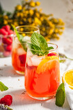 Cold drink. Orange drink with mint and fruits. Fresh drink in glass. Summer drink. Drink from beach bar.