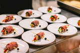 Fototapeta  - chef is serving meat rolls as starter appetizer filled with fresh veggies on the catering food court event