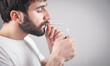 © andranik123 - Caucasian bearded man smoking cigarette in office.