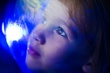 Wall Mural - girl dreams of becoming astronaut and flying into space. reflection of planet
