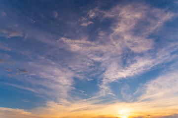 Wall Mural - sunset / sun rise sky with rays of yellow and red light shining clouds and sky background and textur