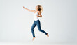 © SHOTPRIME STUDIO - pretty woman in jeans movements dance barefoot light background