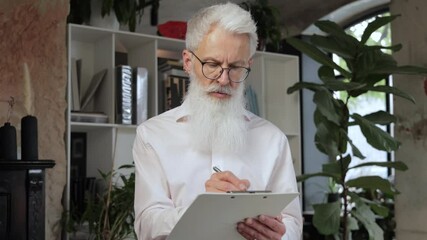 Sticker - Focused mature businessman working and taking notes in his modern office. Slow motion.