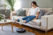 © dragonstock - Robot vacuum cleaner cleaning the living room.
