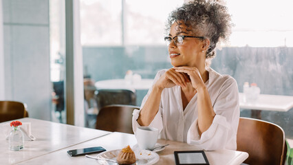 Wall Mural - Successful businesswoman looking away thoughtfully