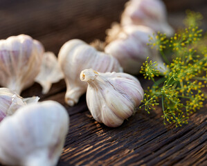 Garlic from natural organic farming on a wooden table, focus on the garlic inside,  close up view