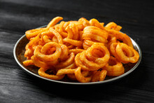 Golden Spicy Seasoned Curly Fries On Rustic Plate. Ready To Eat
