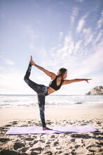 Woman Doing Natarajasana Yoga Pose Along The Seashore