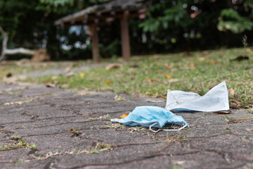 Wall Mural - Litter of used surgical face mask with high usage due to covid pandemic polutes the environment