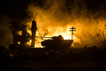 War Concept. Military silhouettes fighting scene on war fog sky background, World War Soldiers Silhouette Below Cloudy Skyline At night. Battle in ruined city. Selective focus