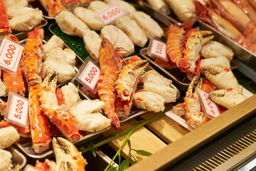 Sticker - Steamed snow crab on display with price tags in a traditional market