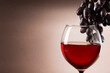 Glass of red wine and red grape. Wine composition with copy space for design.