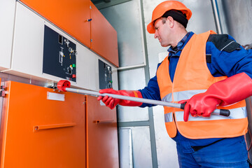 Wall Mural - the engineer checks the absence of induced voltage on the high voltage cells