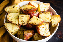 Tuscan Roasted Red Potatoes In A Serving Bowl: Roasted Red Potatoes Coated In Olive Oil, Spices, And Garlic