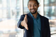 © fizkes - Close up focus on outstretched arm of young african american businessman welcoming new partner or employee, showing polite attitude, ready handshaking with partner, proposing good deal to client.