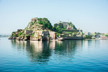 Wall Mural - view of the fortress of corfu from the sea in the morning mist with a steamer in the distance, greec