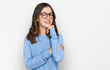 © Krakenimages.com - Young beautiful woman wearing casual clothes and glasses with hand on chin thinking about question, pensive expression. smiling and thoughtful face. doubt concept.