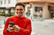 © Krakenimages.com - Handsome african american man outdoors using smartphone typing a message