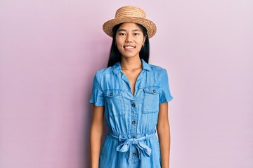 Sticker - Young chinese woman wearing summer hat with a happy and cool smile on face. lucky person.