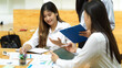 © bongkarn - Asian business team consulting about company loan comparison together