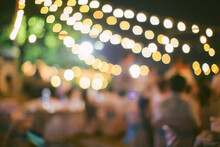 Vintage Tone Blur Image Of Food Stall At Night Festival With Bokeh For Background Usage. Festival Event Party With People Blurred Background. Blur People Having Sunset Beach Party In Summer Vacation