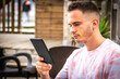 © tetxu - man with digital tablet or ebook in outdoor cafe
