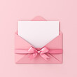 Blank note paper in pink envelope with pink ribbon bow isolated on pink pastel color background with shadow gift voucher card minimal conceptual 3D rendering