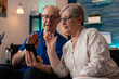© DC Studio - Retired people on smartphone video call together using wireless internet online connection for communication with family. Caucasian senior married couple on technology device gadget