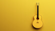 Classical acoustic guitar on yellow background.