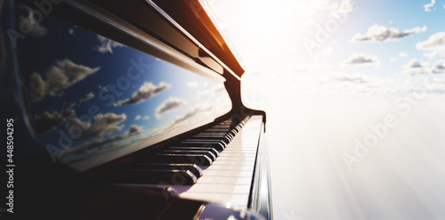 Grand piano keyboard on blue sky