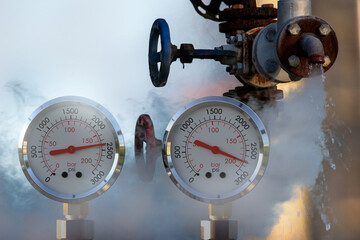 Wall Mural - water pressure gauge meters against a leaky pipeline which comes out hot steam and hot water under pressure