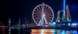 Fototapeta Miasto - Szczecin, Poland, July 2021: Night amusement park, beautiful illuminations photographed in motion