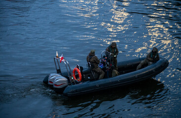 Wall Mural - Soldiers of marine special forces on a pontoon during a night operation on the sea