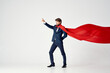 © SHOTPRIME STUDIO - business man in suit red cloak superhero manager light background
