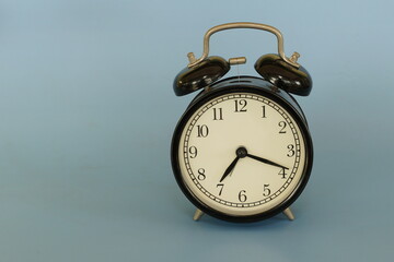 alarm clock isolated on blue background