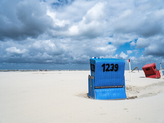 Wall Mural - beach chair at the north sea coast on a cloudy day