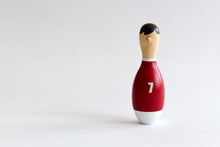 Wooden Puppet In The Shape Of A Bowling Pin With A Number Seven Shirt