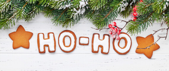 Wall Mural - Christmas greeting card with gingerbread HO-HO text