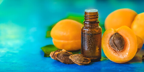 Apricot kernel oil in a bottle. Selective focus.