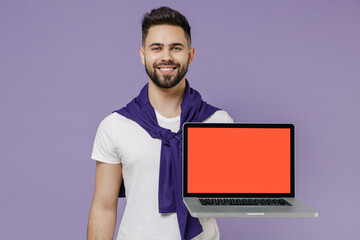 Wall Mural - Happy smiling cheerful young brunet man 20s wears white t-shirt purple shirt hold use work on laptop pc computer with blank screen workspace area isolated on pastel violet background studio portrait
