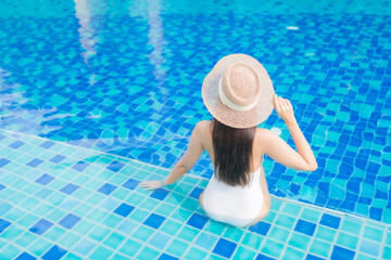 Wall Mural - Portrait beautiful young asian woman relax smile around outdoor swimming pool